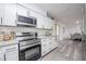 Well-equipped kitchen with stainless steel appliances, ample counter space, and modern white cabinets at 4921 Sharon Ave, Lakeland, FL 33812