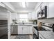 Bright kitchen featuring stainless steel appliances, white cabinets, and updated countertops for cooking at 4921 Sharon Ave, Lakeland, FL 33812
