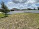 Backyard featuring a full lawn, white fencing, and a tree on the side at 516 Ingleside Ln, Haines City, FL 33844