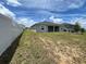 Backyard featuring a full lawn, a white fence, and the back of the house at 516 Ingleside Ln, Haines City, FL 33844