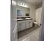 Bright bathroom featuring double sinks, tile flooring, and a shower with a curtain at 516 Ingleside Ln, Haines City, FL 33844