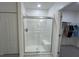 Bathroom with a glass enclosed shower with a built-in seat, and a door to the closet at 516 Ingleside Ln, Haines City, FL 33844
