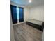 Comfortable bedroom with blue curtains, and hardwood flooring at 516 Ingleside Ln, Haines City, FL 33844