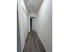Long hallway with wood flooring, a closet, and neutral wall color at 516 Ingleside Ln, Haines City, FL 33844