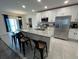 Modern kitchen with stainless steel appliances, granite countertops, and a breakfast bar at 516 Ingleside Ln, Haines City, FL 33844