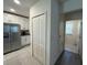 Open-concept kitchen layout featuring stainless steel appliances and easy access to laundry at 516 Ingleside Ln, Haines City, FL 33844