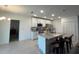 Bright kitchen with white cabinets, stainless appliances, granite counters, and breakfast bar at 516 Ingleside Ln, Haines City, FL 33844