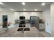 Well lit kitchen featuring stainless steel appliances, island with sink and barstool seating at 516 Ingleside Ln, Haines City, FL 33844