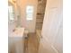 Bright bathroom featuring a tub, a vanity with storage, and a linen closet for essentials at 520 Oakland Rd, Auburndale, FL 33823