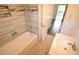 Updated bathroom featuring a shower and tub combo, contemporary tile accents, and a bright vanity at 520 Oakland Rd, Auburndale, FL 33823