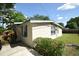 Well-kept home featuring a lush green lawn, mature landscaping and trees, and a paved driveway at 520 Oakland Rd, Auburndale, FL 33823