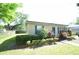 Cozy single-story home with blue shutters, green landscaping, and lush green lawn at 520 Oakland Rd, Auburndale, FL 33823