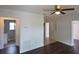 Bright living room featuring hardwood floors, neutral wall color, and open access to a bathroom at 520 Oakland Rd, Auburndale, FL 33823
