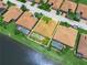 Aerial shot showcases the home's spacious lot, screened pool, and proximity to the serene lake at 5200 Pebble Beach Blvd, Winter Haven, FL 33884
