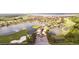 Aerial shot of the community entrance, highlighting water features, lush greenery, and access to the golf course at 5200 Pebble Beach Blvd, Winter Haven, FL 33884