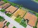 Aerial view of the home highlighting the well-maintained lawn, screened pool, and beautiful landscaping at 5200 Pebble Beach Blvd, Winter Haven, FL 33884