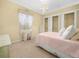 A bright bedroom featuring a classic white bed frame and three closets for ample storage at 5200 Pebble Beach Blvd, Winter Haven, FL 33884