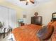 Inviting bedroom featuring a cozy bed, a dresser with a TV, and a comfortable sitting chair at 5200 Pebble Beach Blvd, Winter Haven, FL 33884