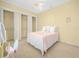 Bright bedroom with a classic white bed frame and three closets for ample storage space at 5200 Pebble Beach Blvd, Winter Haven, FL 33884
