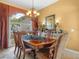 Formal dining room featuring an ornate chandelier, and a large window at 5200 Pebble Beach Blvd, Winter Haven, FL 33884