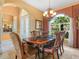Elegant dining room with chandelier, large window, and ornate furnishings at 5200 Pebble Beach Blvd, Winter Haven, FL 33884
