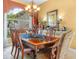 Formal dining room featuring an ornate chandelier, and a large window at 5200 Pebble Beach Blvd, Winter Haven, FL 33884