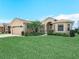 The home features mature landscaping and a well manicured front lawn at 5200 Pebble Beach Blvd, Winter Haven, FL 33884