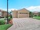 The home has a spacious two car garage and a brick paved driveway at 5200 Pebble Beach Blvd, Winter Haven, FL 33884