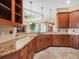 Open kitchen with granite counters, ample cabinet space, and stylish pendant lighting at 5200 Pebble Beach Blvd, Winter Haven, FL 33884