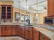 Spacious kitchen features granite countertops, custom cabinetry, and modern fixtures at 5200 Pebble Beach Blvd, Winter Haven, FL 33884