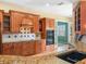 Spacious kitchen features custom wood cabinetry, granite countertops, and stainless steel appliances at 5200 Pebble Beach Blvd, Winter Haven, FL 33884