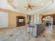 Spacious living room with travertine floors, a decorative ceiling, and an entertainment center at 5200 Pebble Beach Blvd, Winter Haven, FL 33884