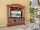 Living room featuring a beautiful entertainment center and tile flooring at 5200 Pebble Beach Blvd, Winter Haven, FL 33884