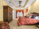 The main bedroom is spacious with coffered ceilings and has a large decorative wardrobe at 5200 Pebble Beach Blvd, Winter Haven, FL 33884