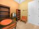 A bright office space featuring bookshelves, a small desk, a bench, and plenty of natural light at 5200 Pebble Beach Blvd, Winter Haven, FL 33884