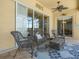 This outdoor patio features stylish wicker seating and a ceiling fan for comfortable entertaining at 5200 Pebble Beach Blvd, Winter Haven, FL 33884