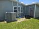 Exterior view of the house with a new HVAC unit, door and a well-maintained lawn at 6685 Briarhill Dr Ne, Winter Haven, FL 33881