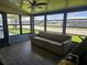 Charming sunroom with floor-to-ceiling windows, ceiling fan and a comfortable couch at 6685 Briarhill Dr Ne, Winter Haven, FL 33881