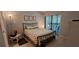 Bedroom featuring a queen bed, bedside table and access to a screened in patio at 7201 Country Club Dr # G21, Lake Wales, FL 33898
