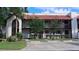 Exterior view of condo building with wood balconies, red tile roof, and well-manicured landscaping at 7201 Country Club Dr # G21, Lake Wales, FL 33898