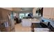 Modern kitchen featuring white cabinets, stainless steel appliances, and an open view to the living area at 7201 Country Club Dr # G21, Lake Wales, FL 33898
