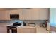 Well-appointed kitchen with stainless steel appliances, white cabinetry, and sleek countertops for culinary enthusiasts at 7201 Country Club Dr # G21, Lake Wales, FL 33898