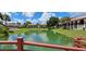 A tranquil lake view showcases the surrounding villas, lush landscaping, and serene atmosphere at 7201 Country Club Dr # G21, Lake Wales, FL 33898