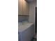 Laundry room featuring a white washer and dryer set with white cabinets above at 7201 Country Club Dr # G21, Lake Wales, FL 33898