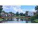 Picturesque view of a wooden bridge spanning a serene pond with building in the background at 7201 Country Club Dr # G21, Lake Wales, FL 33898