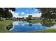 Scenic pond view with a charming wooden bridge reflecting the blue sky at 7201 Country Club Dr # G21, Lake Wales, FL 33898