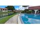 Community pool beside a tranquil lake and bridge, showcasing serene outdoor living at 7201 Country Club Dr # G21, Lake Wales, FL 33898