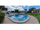 Community pool with clear blue water, surrounded by a spacious deck and lush landscaping at 7201 Country Club Dr # G21, Lake Wales, FL 33898