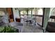 Bright sunroom featuring tile flooring, a rug and several workspaces at 7201 Country Club Dr # G21, Lake Wales, FL 33898