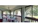 Bright sunroom filled with sewing tables and machinery with large glass windows at 7201 Country Club Dr # G21, Lake Wales, FL 33898